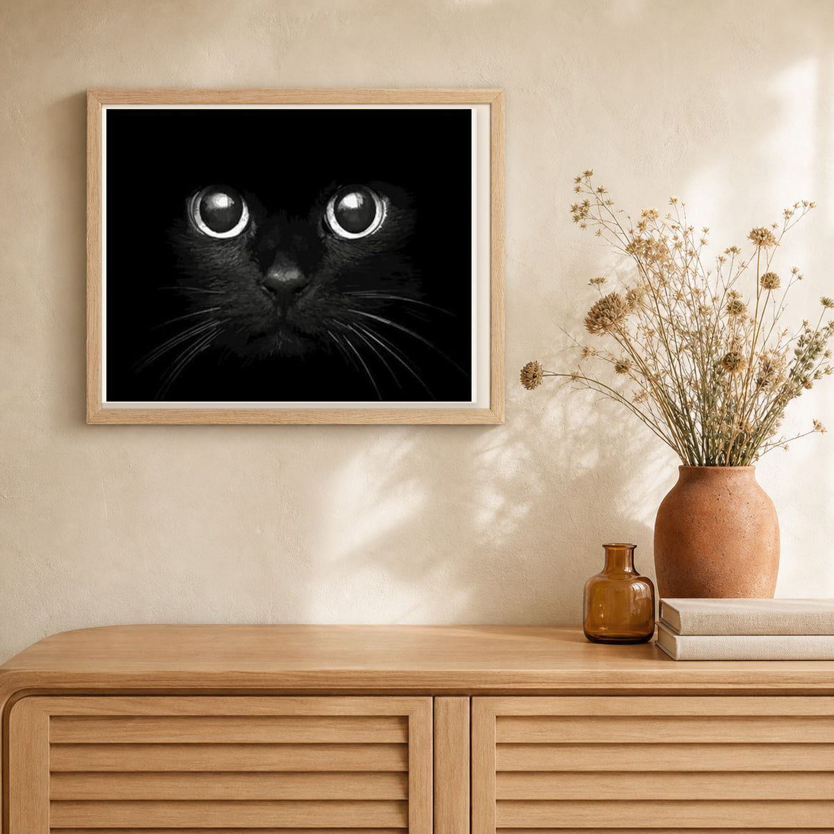 Black Cat Head artwork displayed in a warm interior