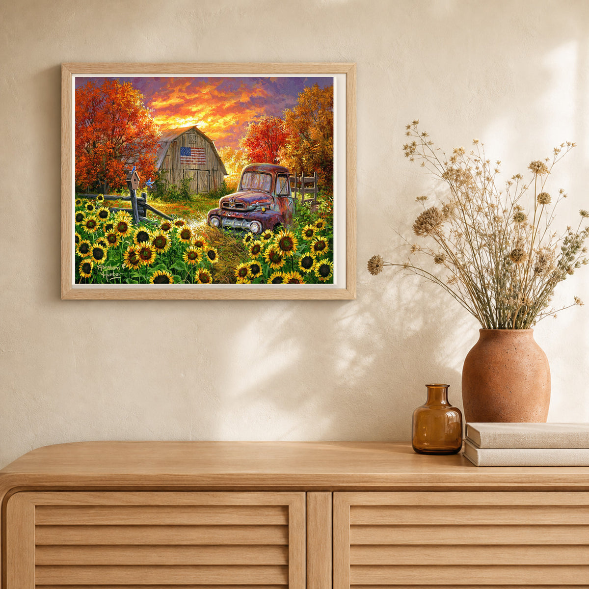 Sunflowers in front of the barn artwork displayed in a warm interior