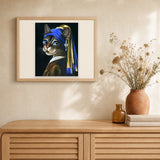 Young kitten with a pearl artwork displayed in a warm interior