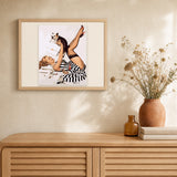 Pin-up wearing a dress and dog artwork displayed in a warm interior