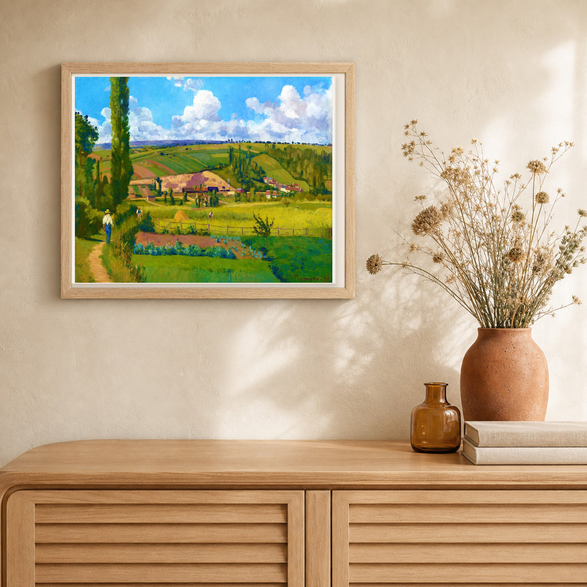 Landscape at Les Pâtis — Camille Pissarro artwork displayed in a warm interior