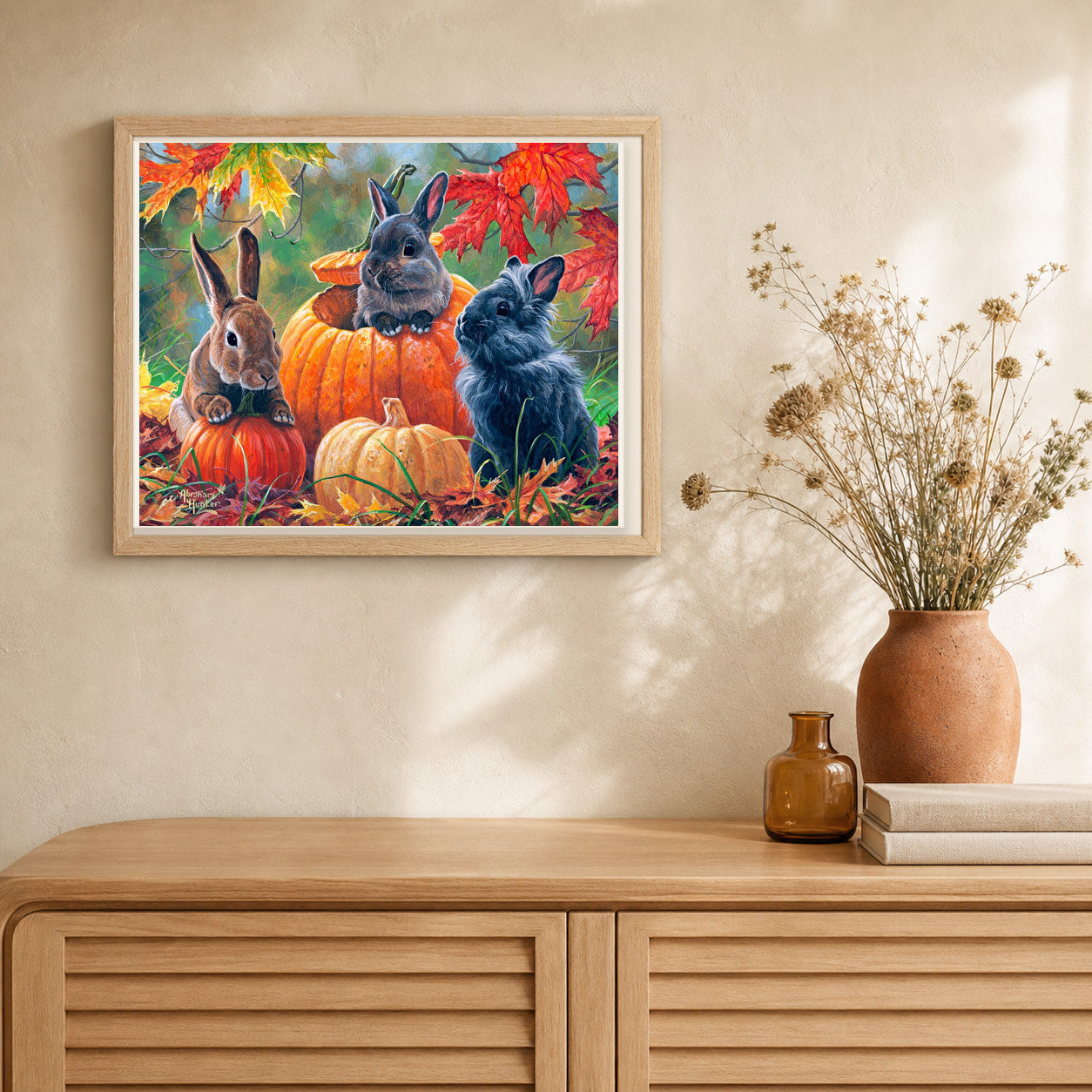 Trio of Rabbits artwork displayed in a warm interior