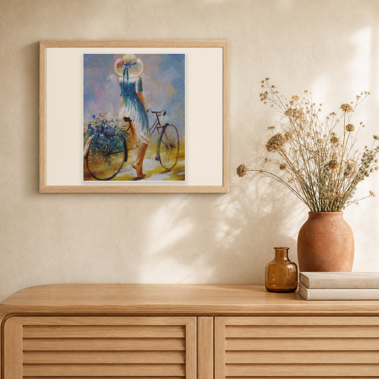 Young woman on a bicycle artwork displayed in a warm interior